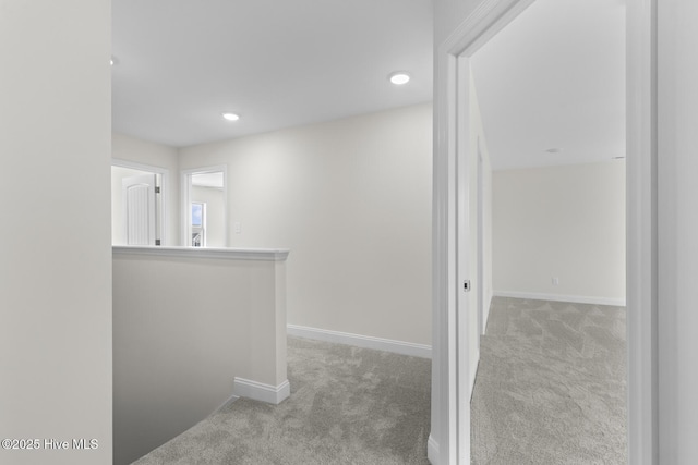 corridor featuring recessed lighting, baseboards, and carpet floors