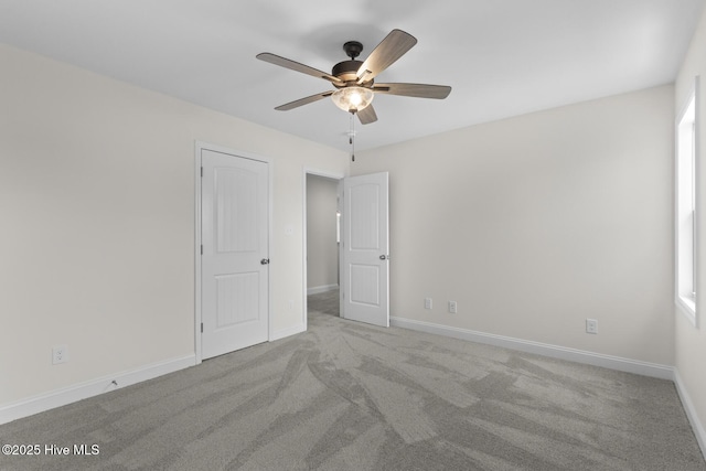 unfurnished bedroom with ceiling fan, baseboards, and carpet floors