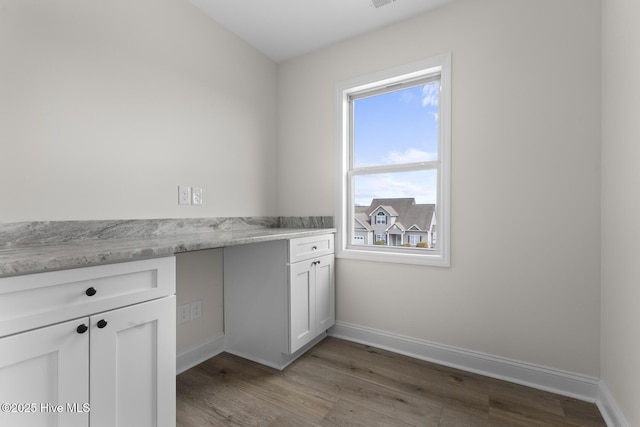 laundry area with baseboards and light wood-type flooring