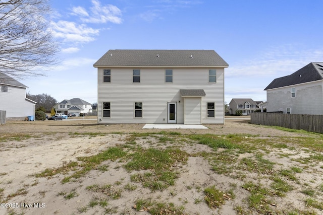 rear view of house featuring fence and a patio area