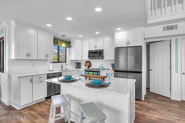 kitchen featuring stainless steel appliances, white cabinets, and a kitchen island