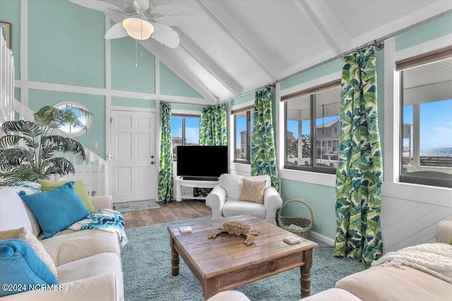 sunroom with ceiling fan and vaulted ceiling