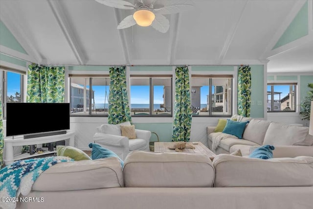 living room featuring vaulted ceiling with beams and ceiling fan