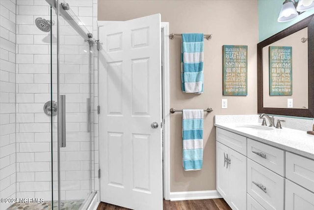 bathroom featuring vanity, hardwood / wood-style floors, and an enclosed shower