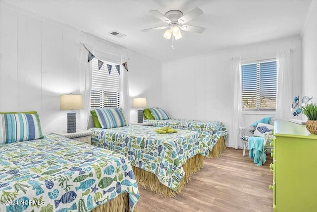 bedroom with wood-type flooring and ceiling fan