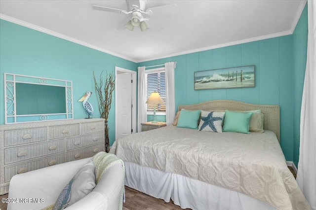 bedroom featuring hardwood / wood-style floors, ornamental molding, and ceiling fan