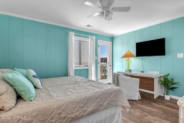 bedroom featuring hardwood / wood-style floors, ornamental molding, ceiling fan, and access to exterior