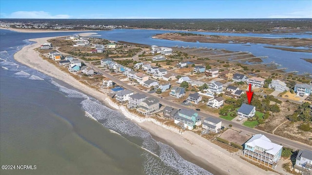 bird's eye view featuring a water view and a beach view