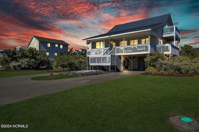 view of front of property featuring a carport, a porch, and a yard