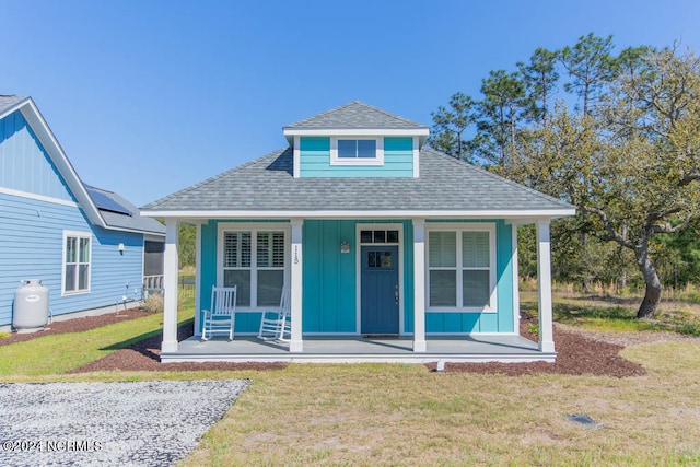 bungalow-style house with a front lawn and a porch