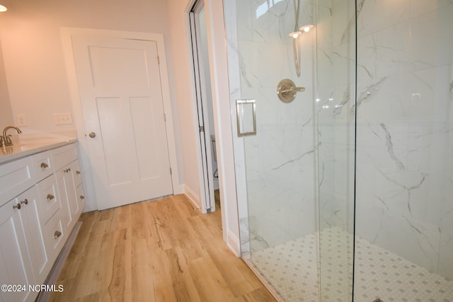 bathroom with a shower with door, vanity, toilet, and wood-type flooring