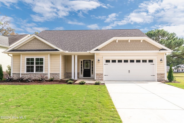 craftsman-style home with a garage and a front lawn