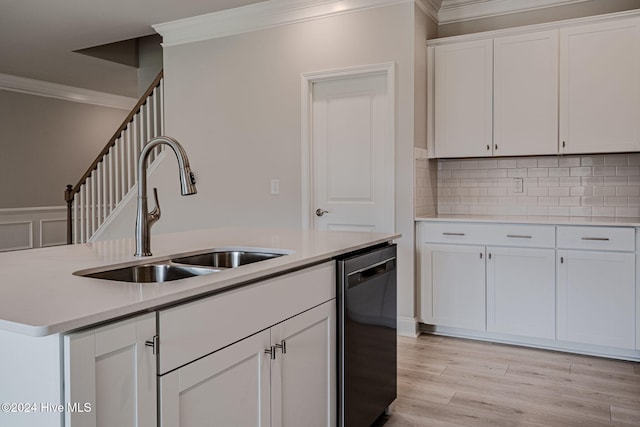 kitchen with white cabinetry, dishwasher, a kitchen island with sink, and sink