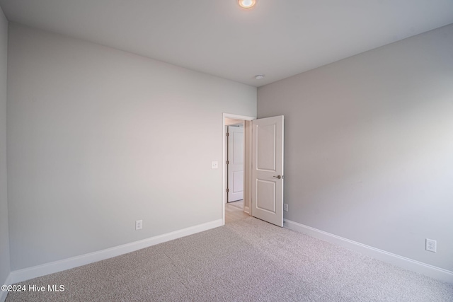 spare room with light colored carpet