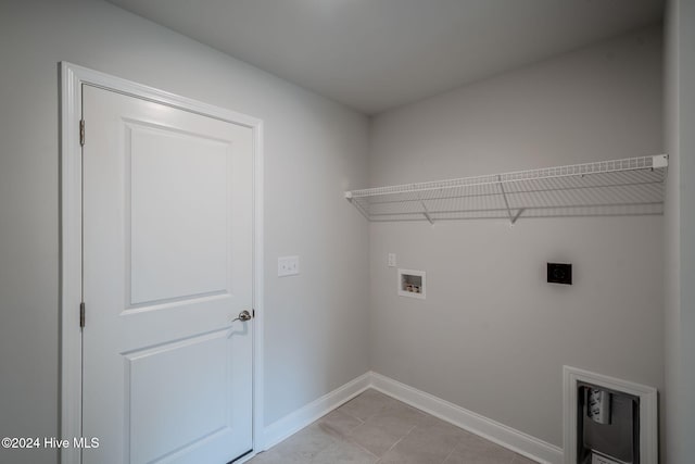 laundry area featuring electric dryer hookup, light tile patterned flooring, and washer hookup