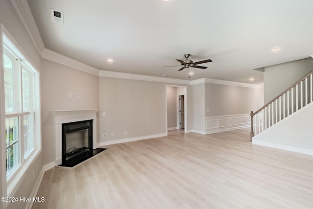 unfurnished living room featuring light hardwood / wood-style flooring, ceiling fan, and ornamental molding