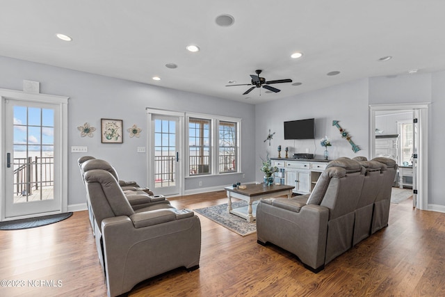 living room featuring ceiling fan and wood-type flooring