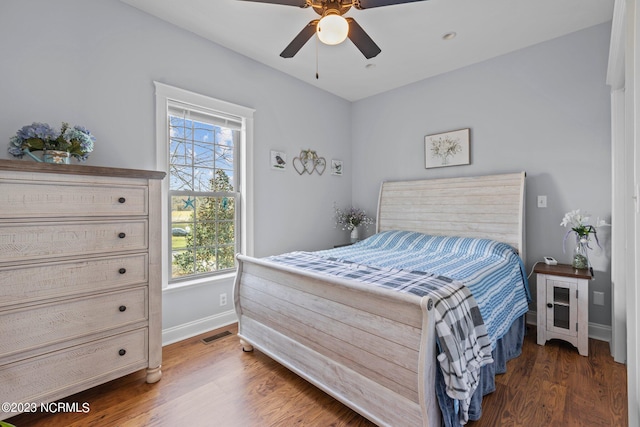 bedroom with ceiling fan and dark hardwood / wood-style floors