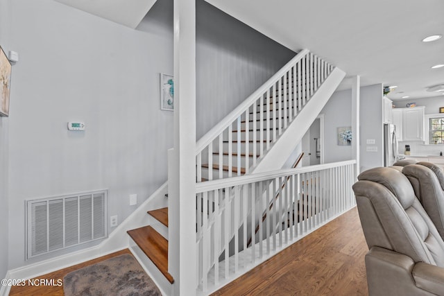 stairway featuring wood-type flooring