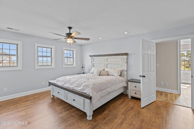 bedroom with ceiling fan and hardwood / wood-style flooring