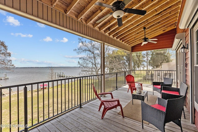 wooden deck featuring a yard, ceiling fan, and a water view