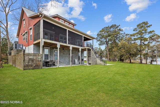 back of house with central AC, a sunroom, a yard, and a patio area