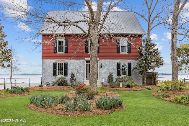 view of front of property featuring a water view and a front lawn