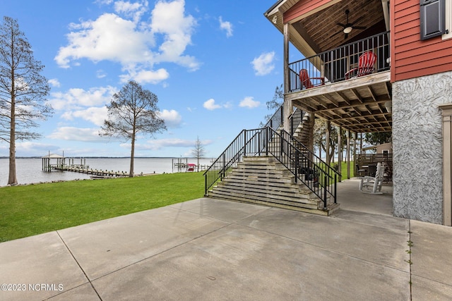 view of patio with ceiling fan and a water view