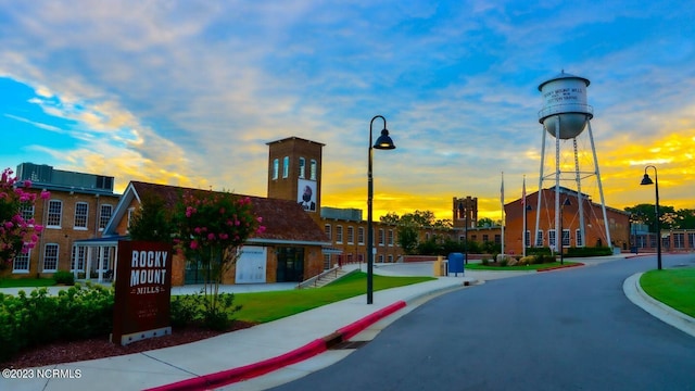 view of road with curbs, sidewalks, and street lights