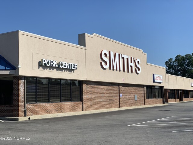 view of building exterior with uncovered parking