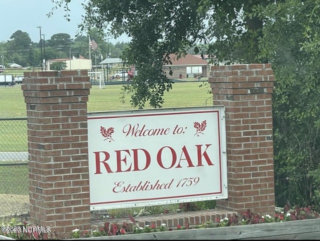 community / neighborhood sign with a lawn