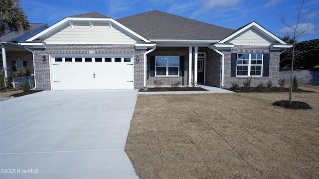 view of front facade featuring a garage, roof with shingles, concrete driveway, and brick siding