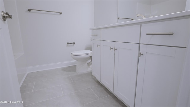 bathroom featuring baseboards, vanity, toilet, and tile patterned floors