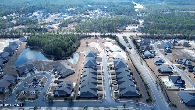 drone / aerial view with a water view and a residential view