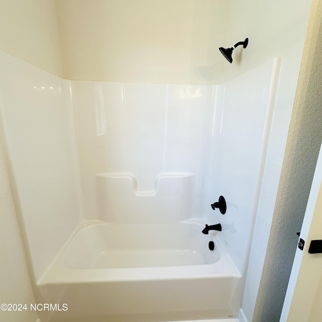 bathroom with bathing tub / shower combination