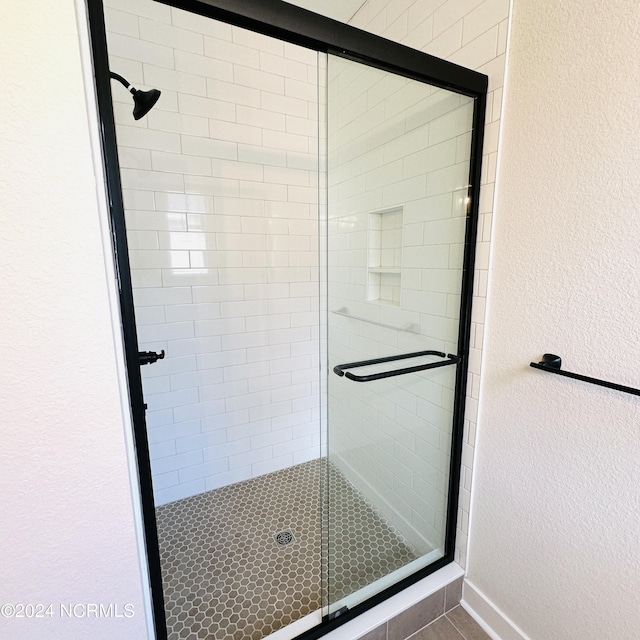 bathroom with a shower with shower door