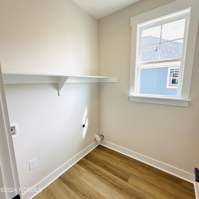 washroom featuring electric dryer hookup and light wood-type flooring