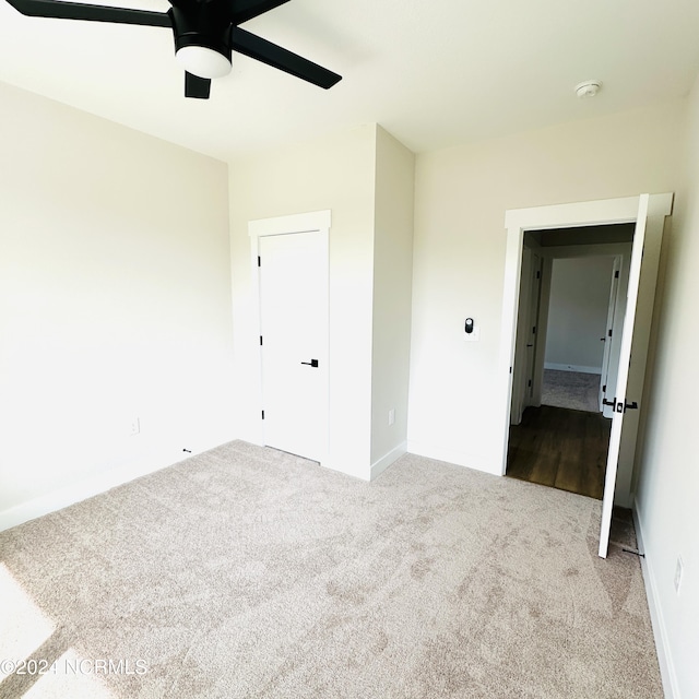 unfurnished bedroom with carpet floors and ceiling fan