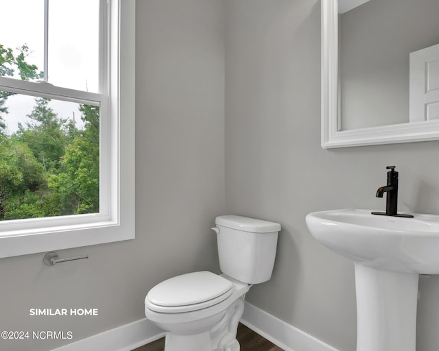 bathroom with toilet and baseboards