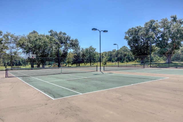 view of tennis court with fence