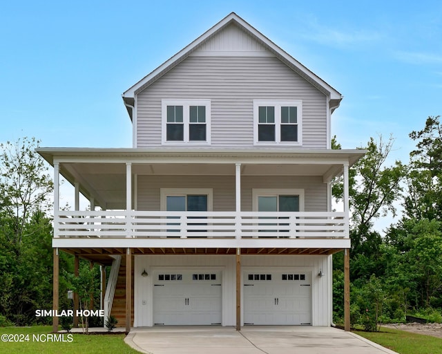 coastal home featuring a garage, driveway, and board and batten siding