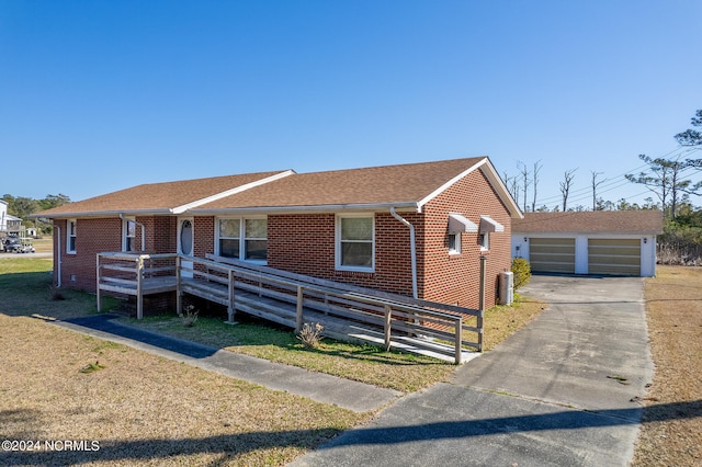 view of front facade featuring central AC, an outdoor structure, and a garage