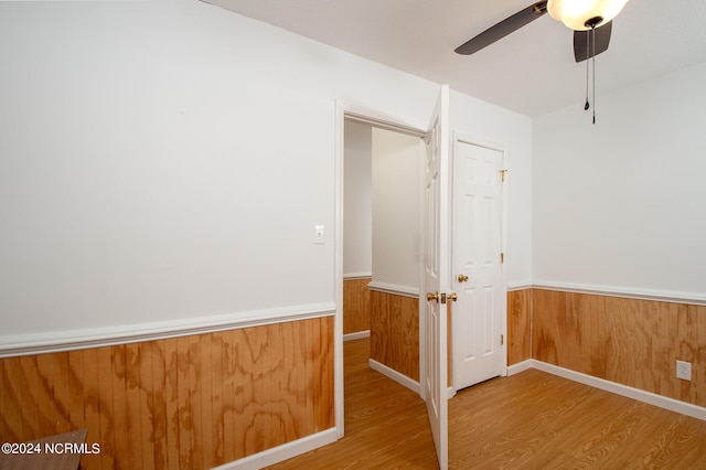 empty room with light hardwood / wood-style flooring and ceiling fan