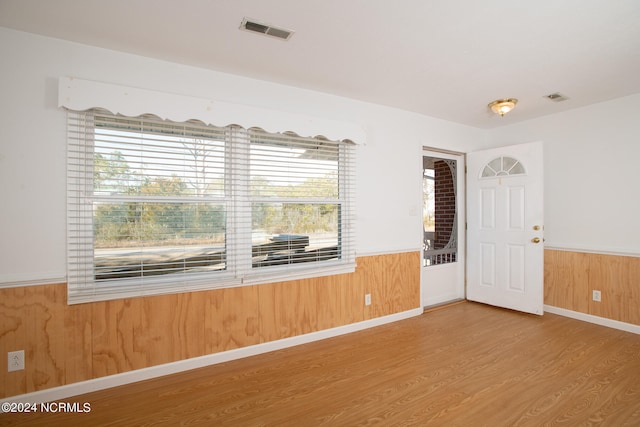 spare room featuring light wood-type flooring and a wealth of natural light