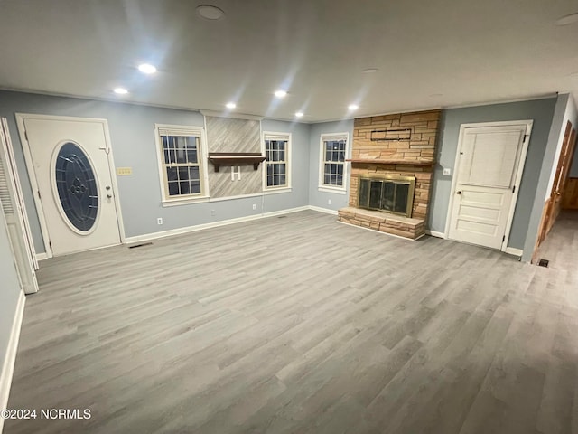 unfurnished living room featuring light hardwood / wood-style floors and a fireplace