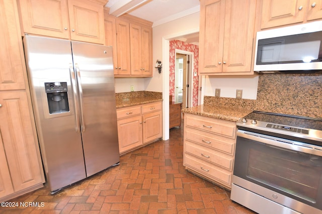 kitchen featuring backsplash, light stone counters, light brown cabinetry, and stainless steel appliances