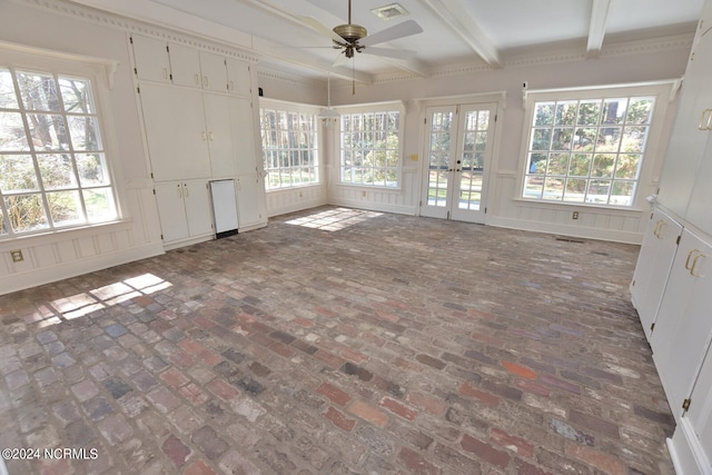 spare room featuring plenty of natural light, ceiling fan, french doors, and beamed ceiling