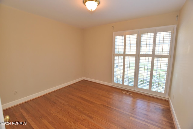 empty room featuring dark hardwood / wood-style flooring