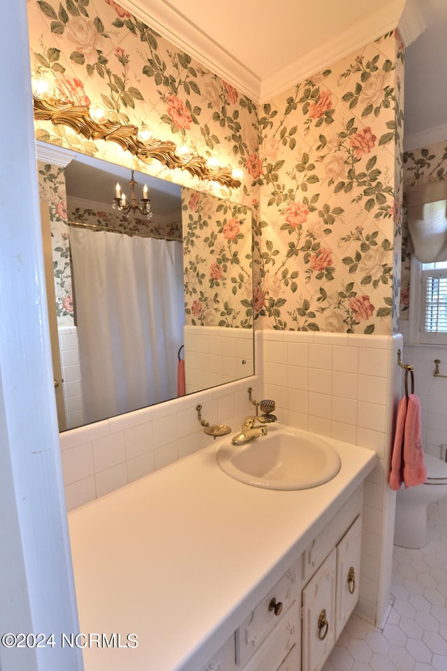 bathroom with an inviting chandelier, tile floors, toilet, ornamental molding, and oversized vanity