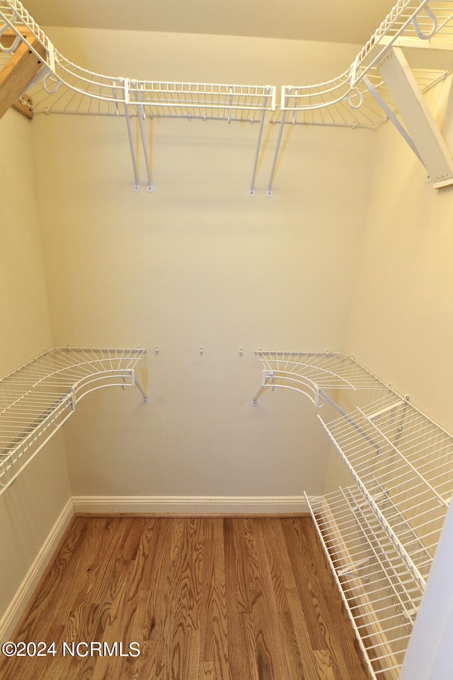 spacious closet featuring hardwood / wood-style floors